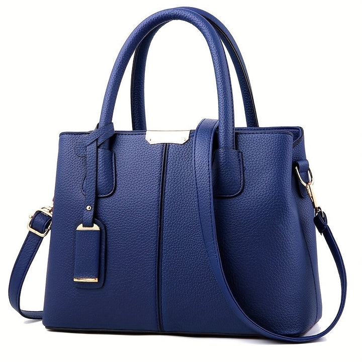 Chic women's leather handbag with a sturdy top handle & detachable crossbody strap for flexible wear.