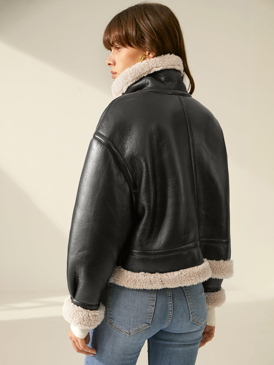 Trendy woman in a warm flight jacket, showcasing stylish winter outerwear & casual fashion.