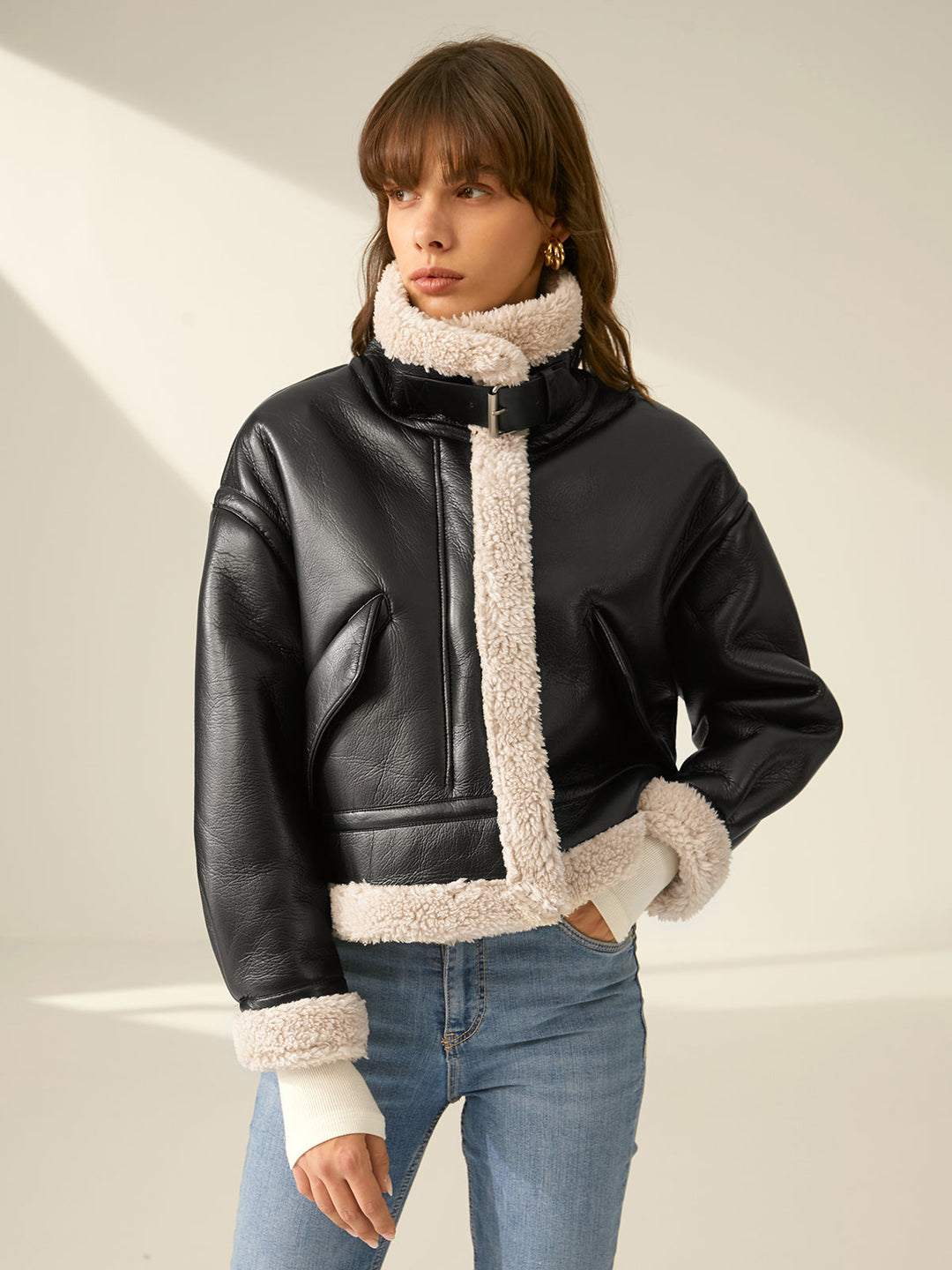 Back view of a woman wearing a fitted, stylish flight jacket, ideal for warm winter layering & fashion.