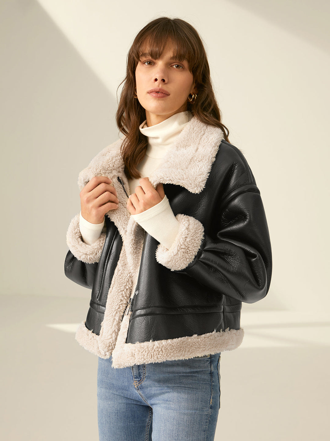 Detail of durable zippers & utility pockets on a women's warm flight jacket, stylish winter outerwear.