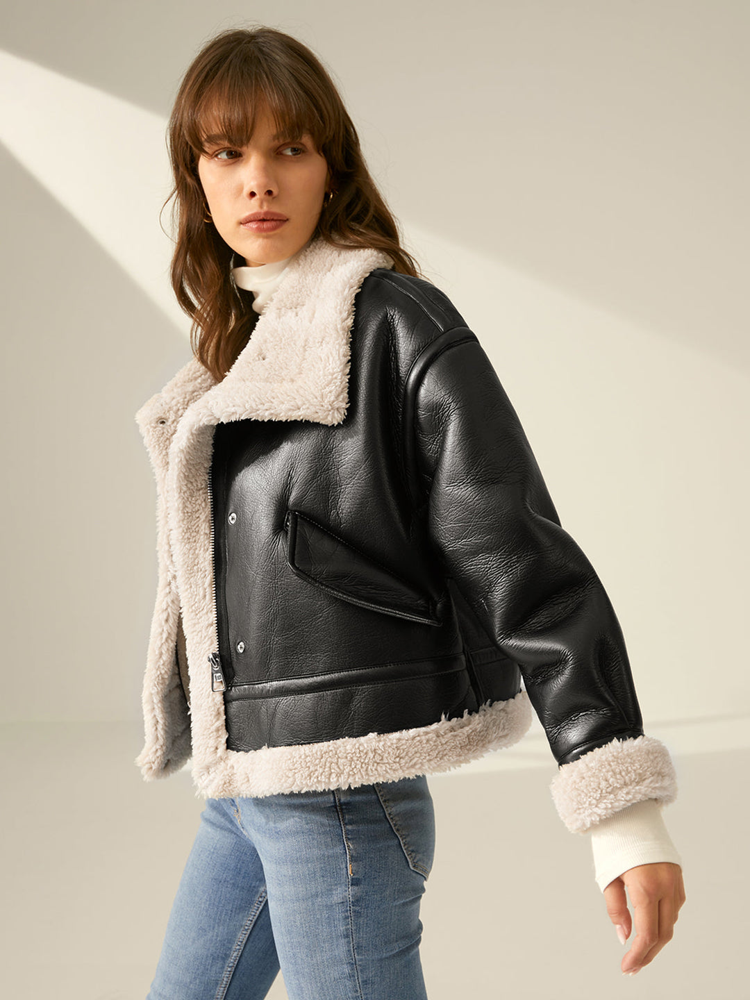 Women's flight jacket styled over a sweater, demonstrating cozy, warm winter layering & trendy fashion.