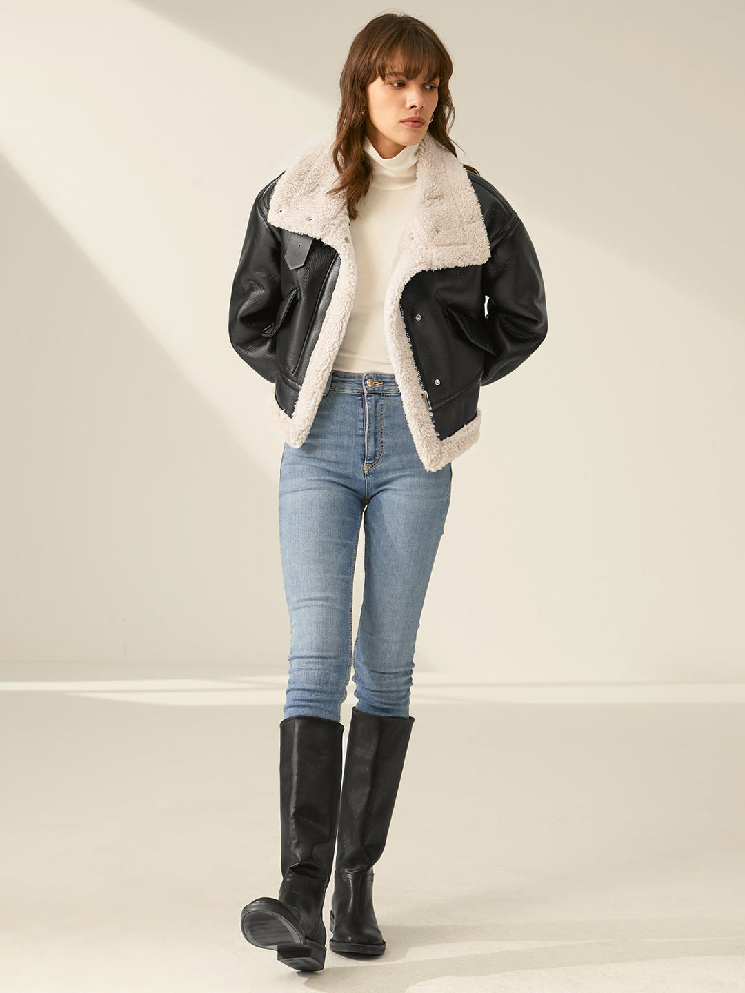Woman enjoying outdoors in a stylish, warm flight jacket. Perfect cozy outerwear for casual winter adventures.