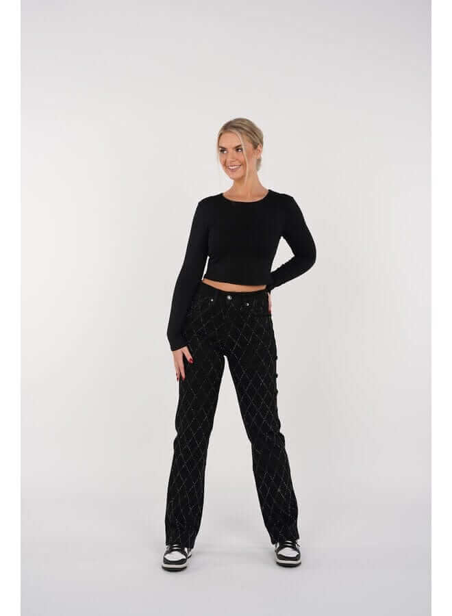 Close-up of women's straight leg denim jeans, showcasing the intricate diamond pattern and quality fabric.