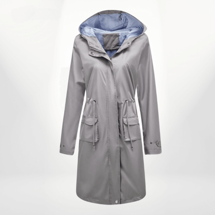 Green women's waterproof over-knee trench coat, a fashionable long rain jacket and stylish outerwear.