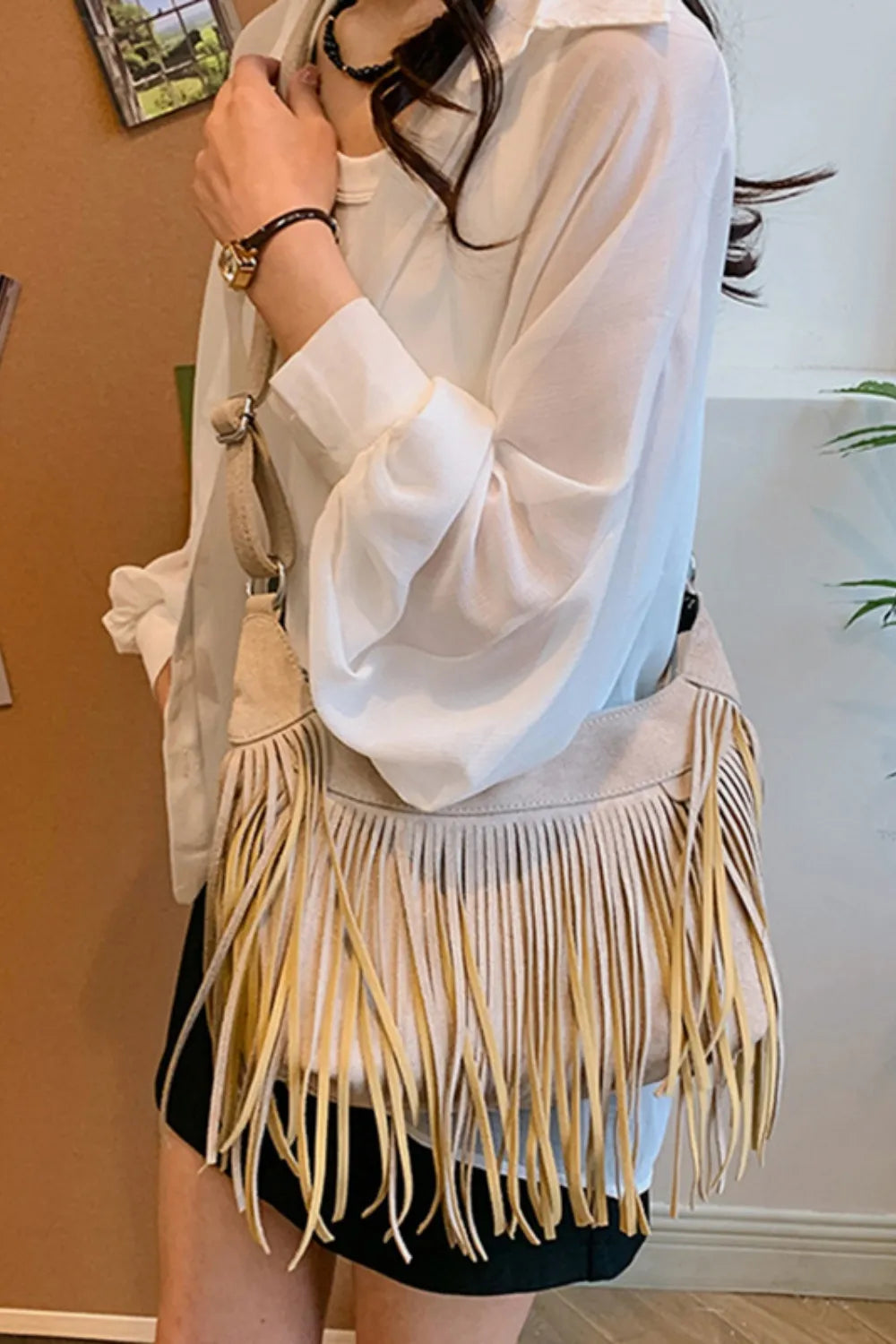 Stylish women's suede fringe crossbody bag with layered fringe and boho charm.