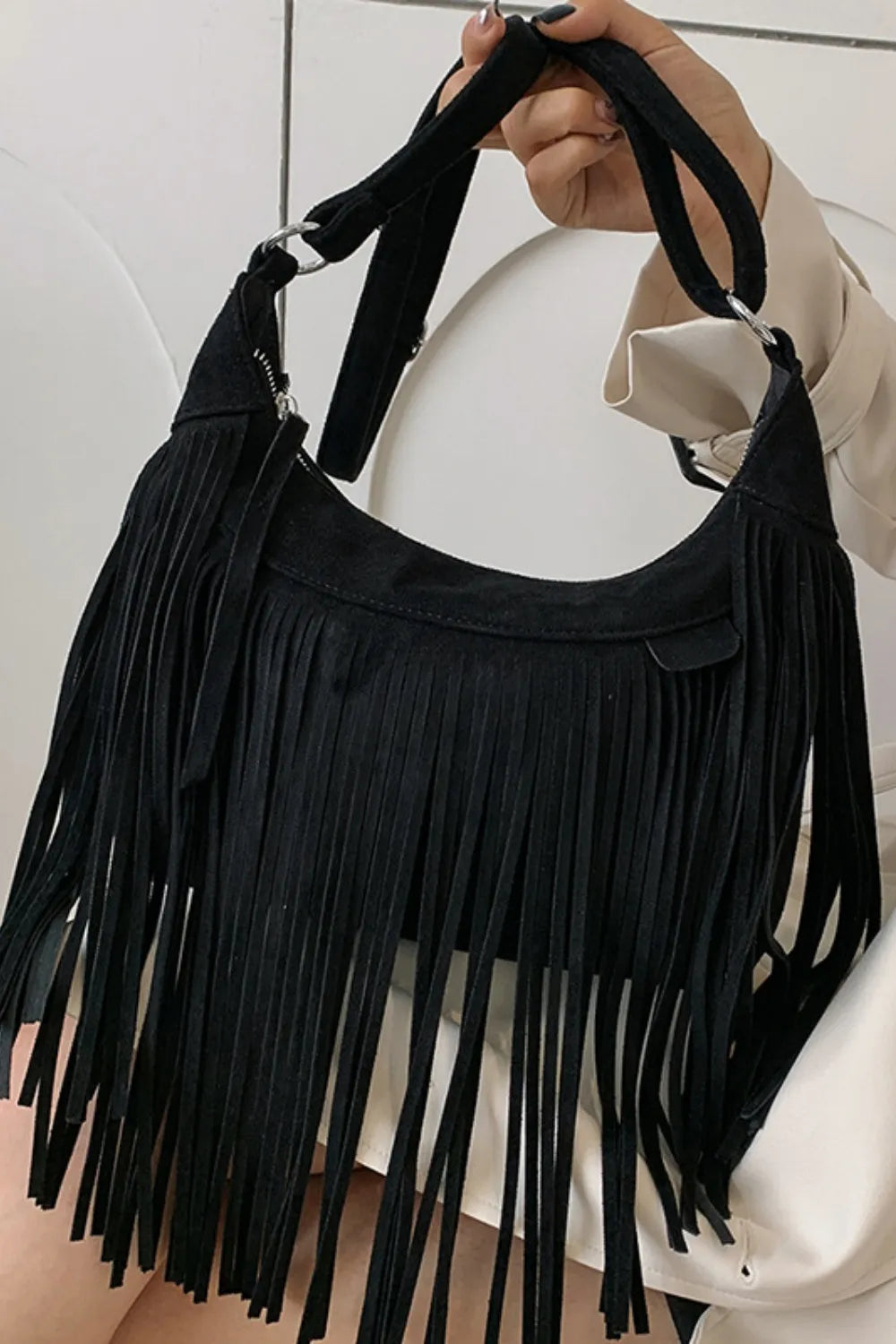 Soft suede fringe crossbody bag for women, embodying a relaxed boho aesthetic.