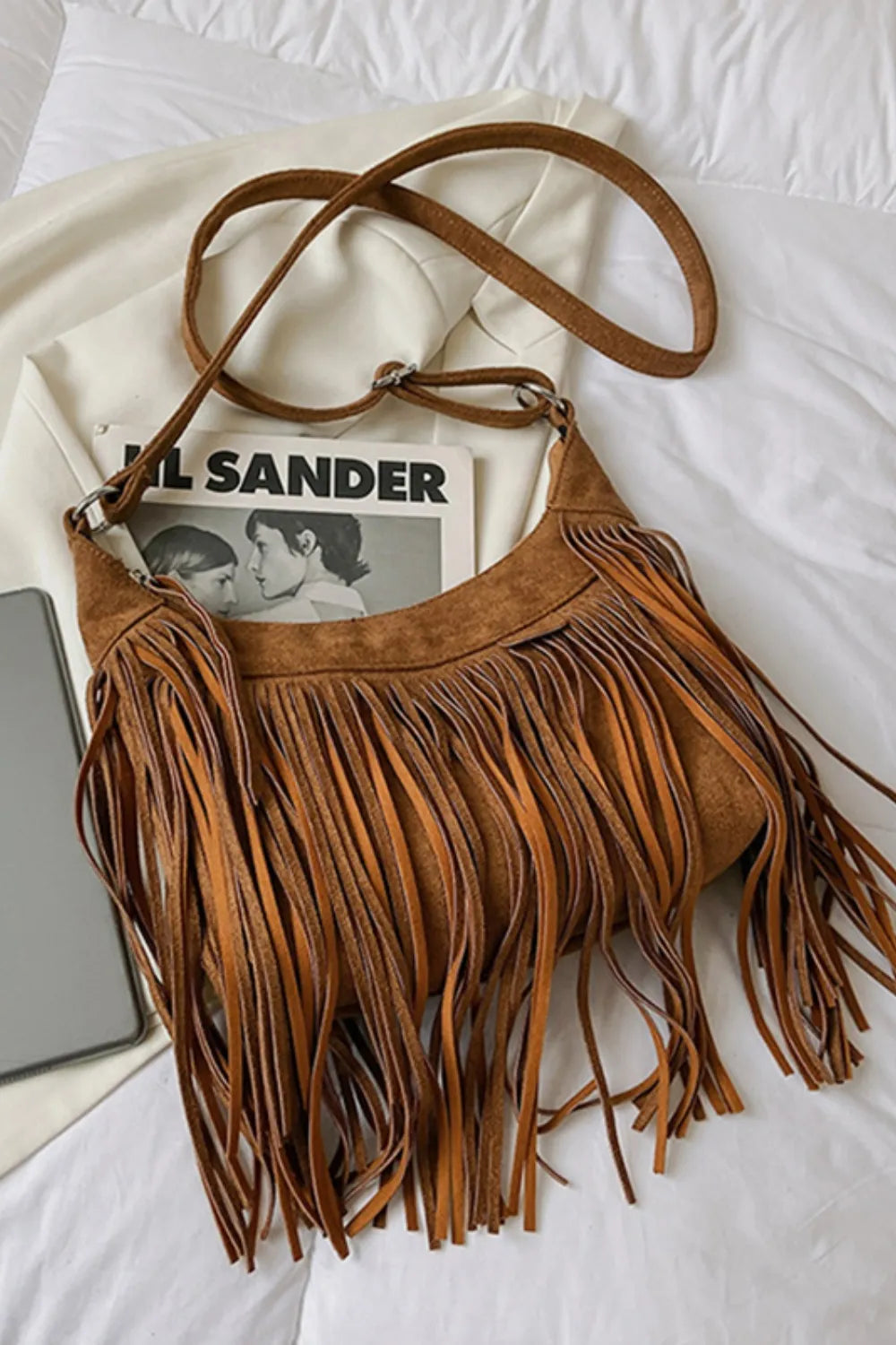 Boho chic women's suede crossbody bag with long fringe and tassel detail.
