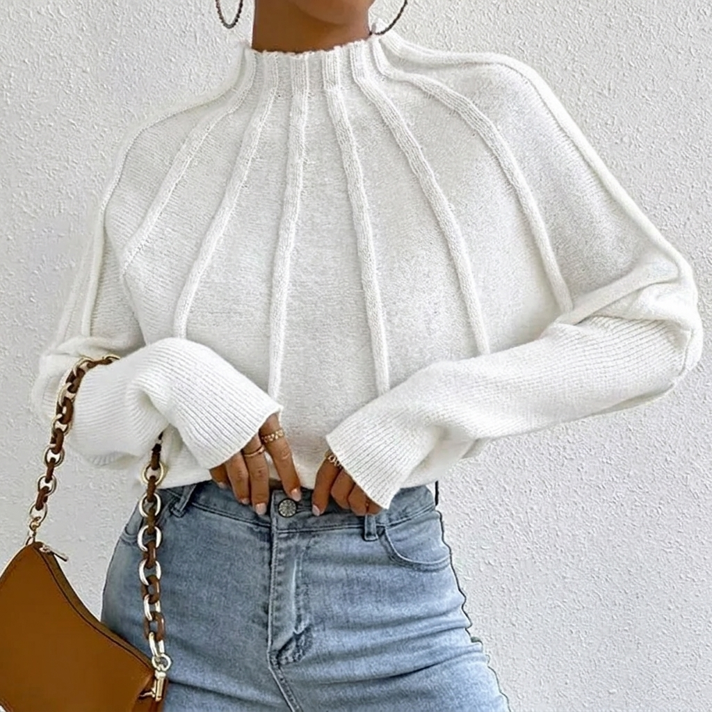 Women's sunburst design jumper with mock neck and batwing sleeves. Perfect for casual chic winter style.