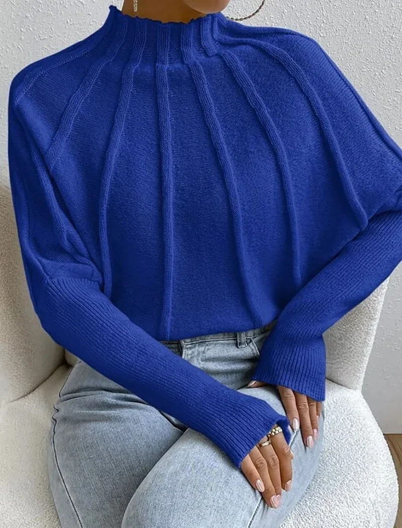 Modern women's mock neck top, a statement jumper with a striking sunburst design and elegant batwing sleeves.