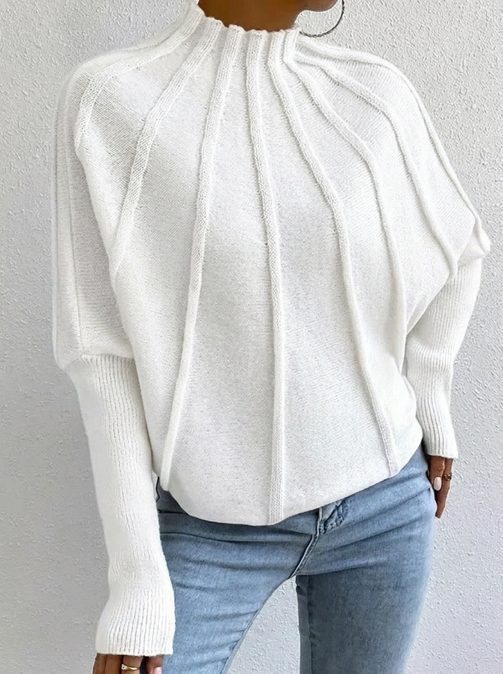Statement women's sunburst pattern sweater featuring a stylish mock neck and elegant batwing sleeves.