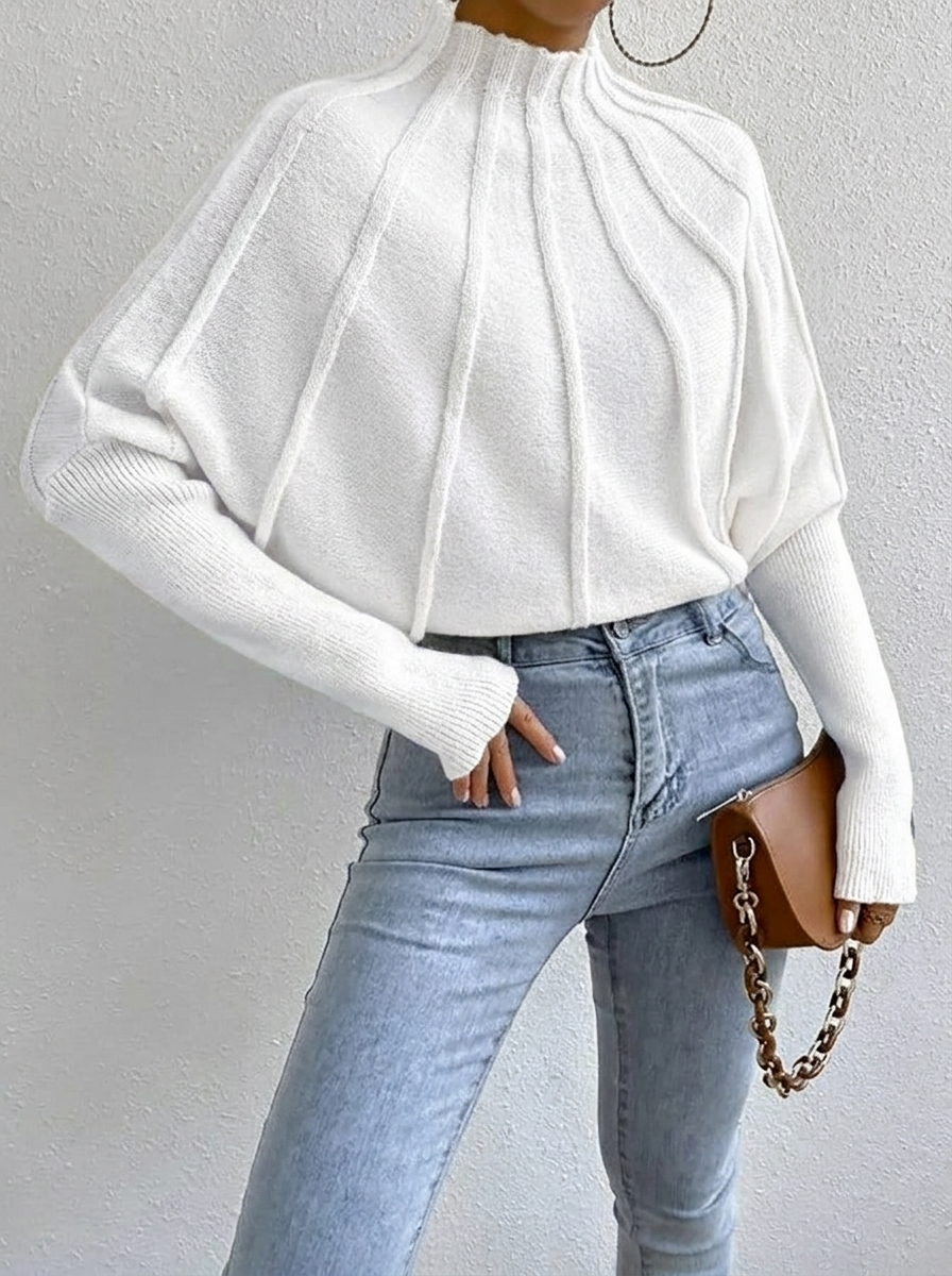Elegant women's batwing sweater with a distinct sunburst pattern and comfortable mock neck, winter fashion.