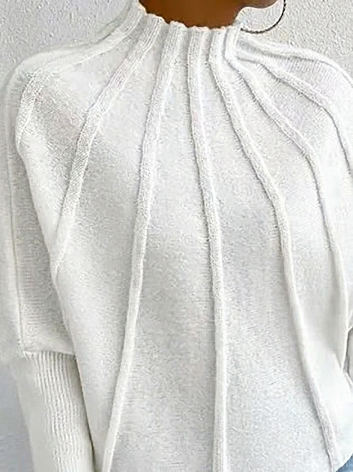 Casual chic women's sunburst design top. Mock neck jumper with flowing batwing sleeves for everyday elegance.