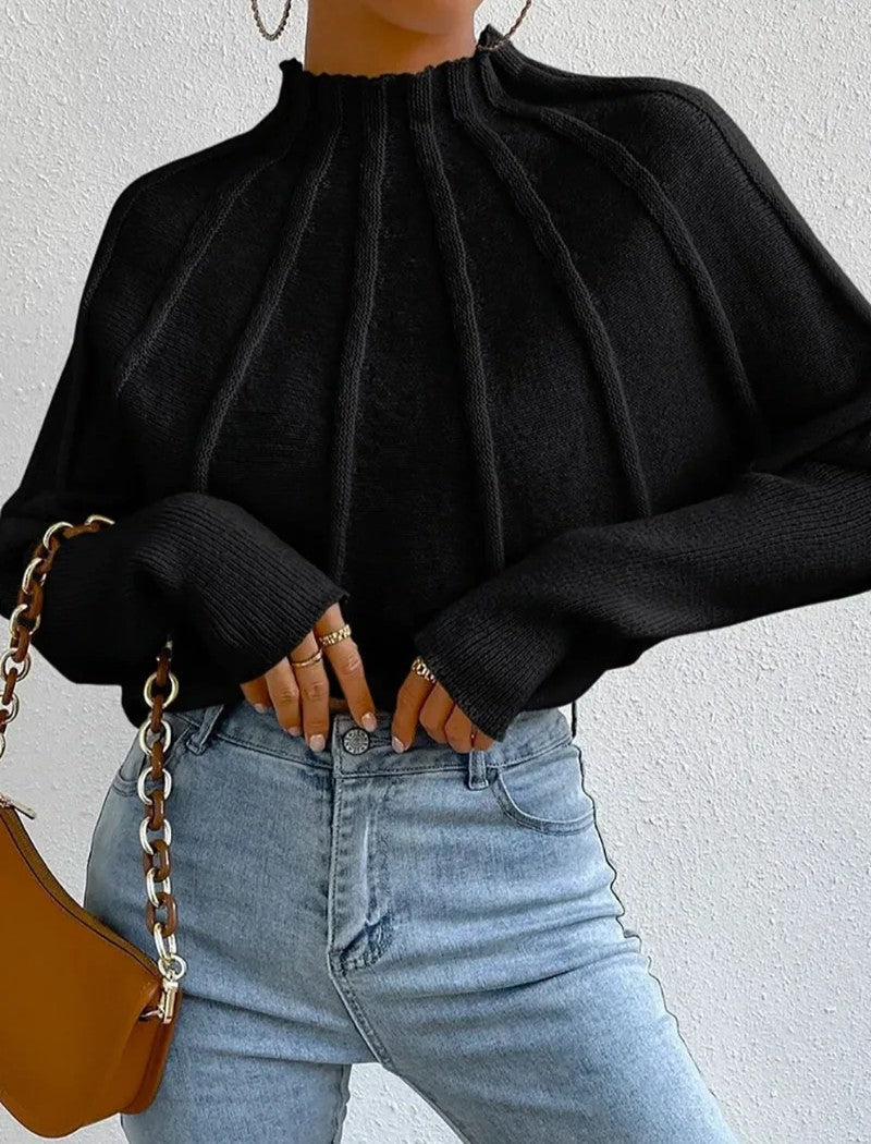 Stylish women's mock neck jumper, showcasing a beautiful sunburst pattern and trendy batwing sleeves.
