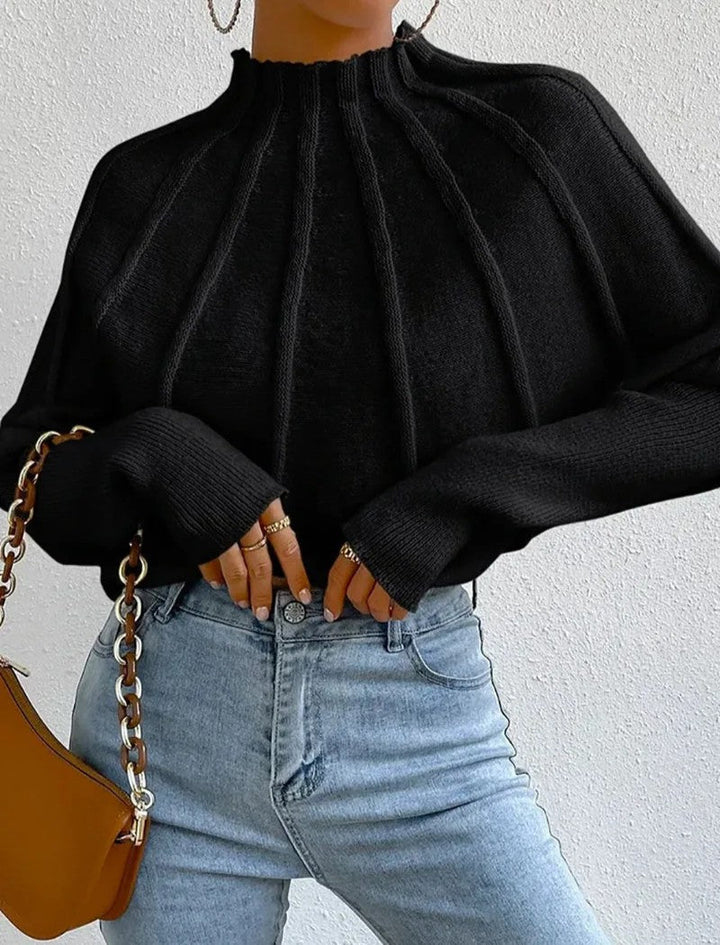 Stylish women's mock neck jumper, showcasing a beautiful sunburst pattern and trendy batwing sleeves.
