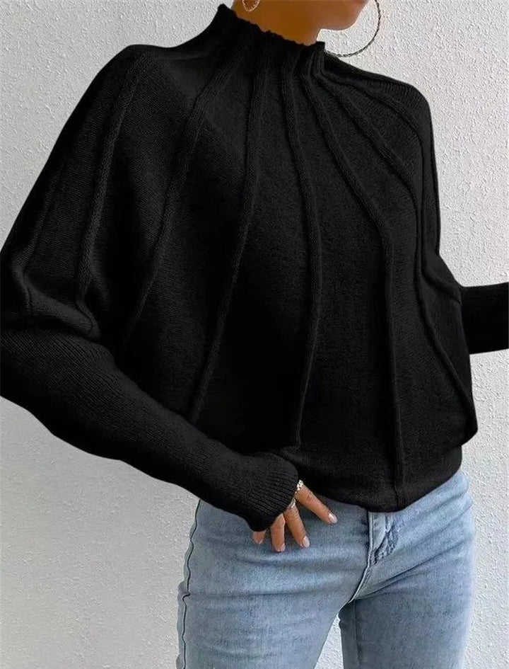 Versatile women's sunburst design batwing sweater, an essential mock neck top for modern winter style.