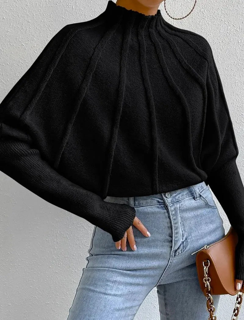 Fashionable women's jumper featuring a unique sunburst pattern, mock neck, and flattering batwing sleeves.