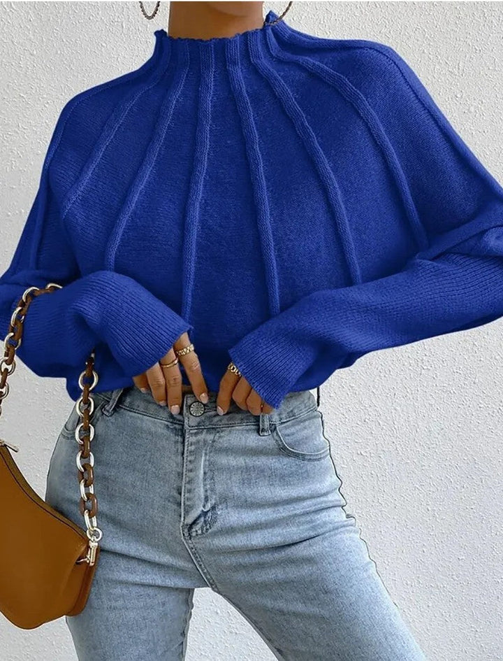 Cozy women's sunburst pattern sweater with a sophisticated mock neck and comfortable batwing sleeve design.