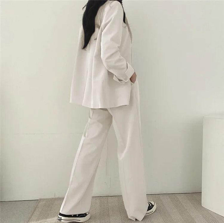 Women's business wear set with a well-fitted tailored blazer and straight-leg pants.