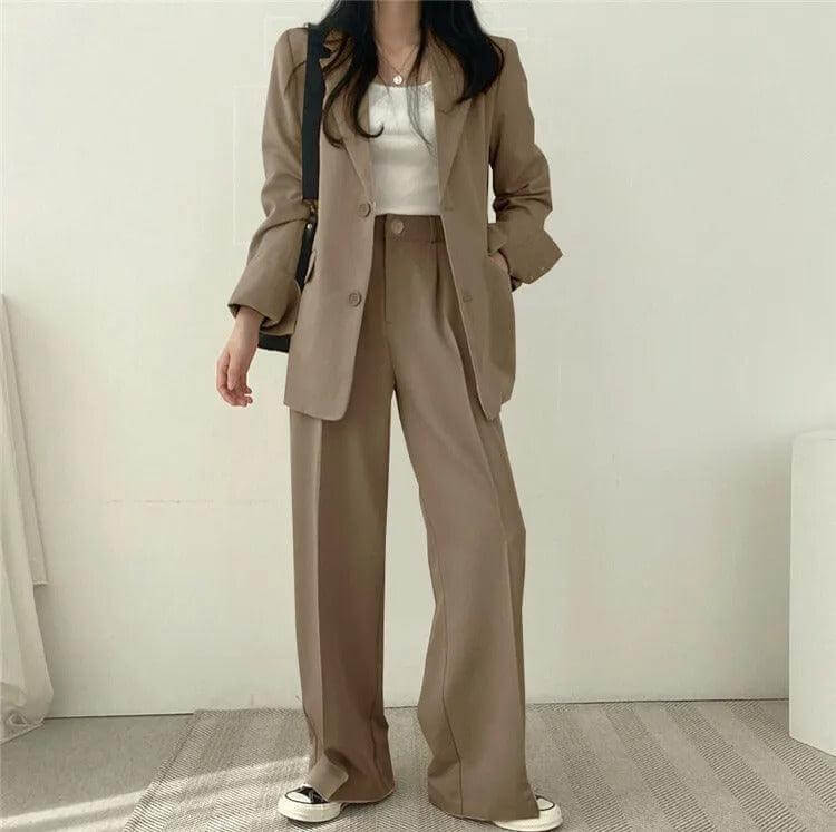 Chic women's tailored blazer and straight-leg pants set, suitable for formal occasions.