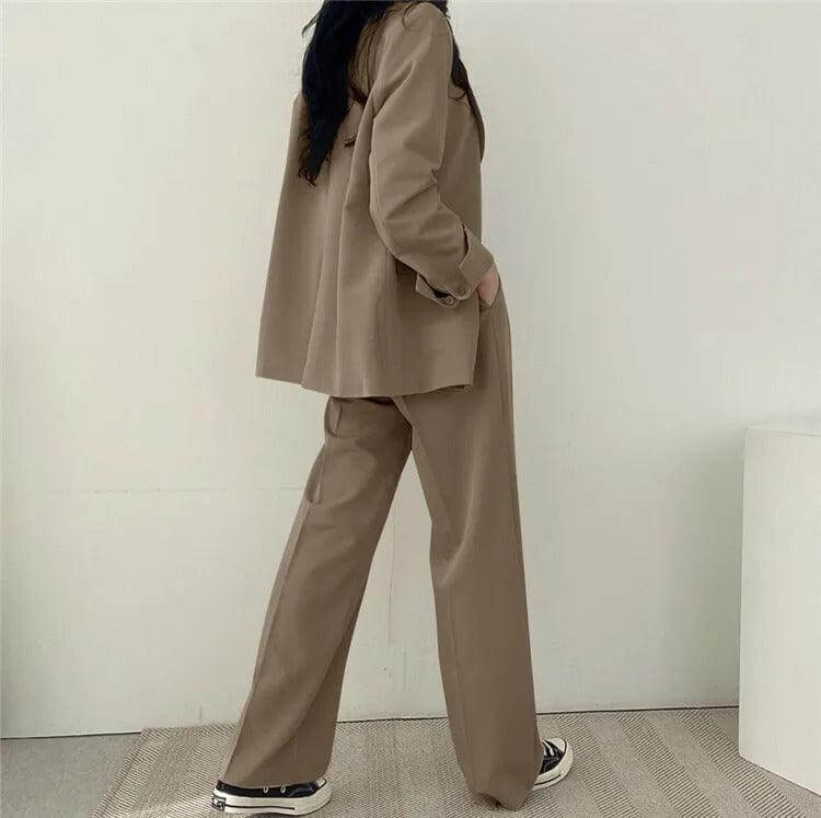 Professional women's tailored blazer paired with comfortable straight-leg pants.