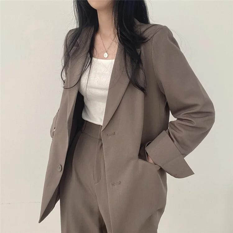Women's two-piece business suit: tailored blazer and straight-leg pants elegance.