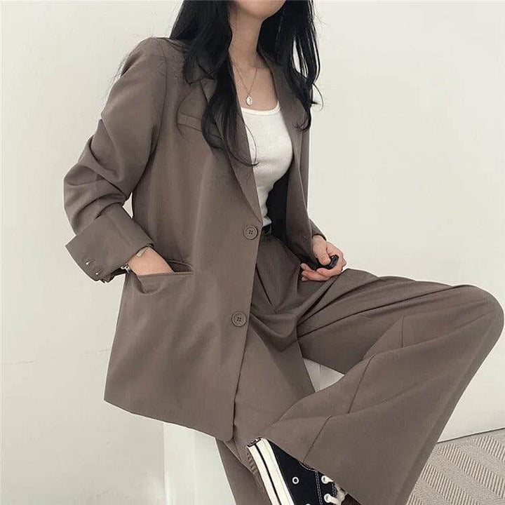 Women's professional style tailored blazer and matching straight-leg pants set.