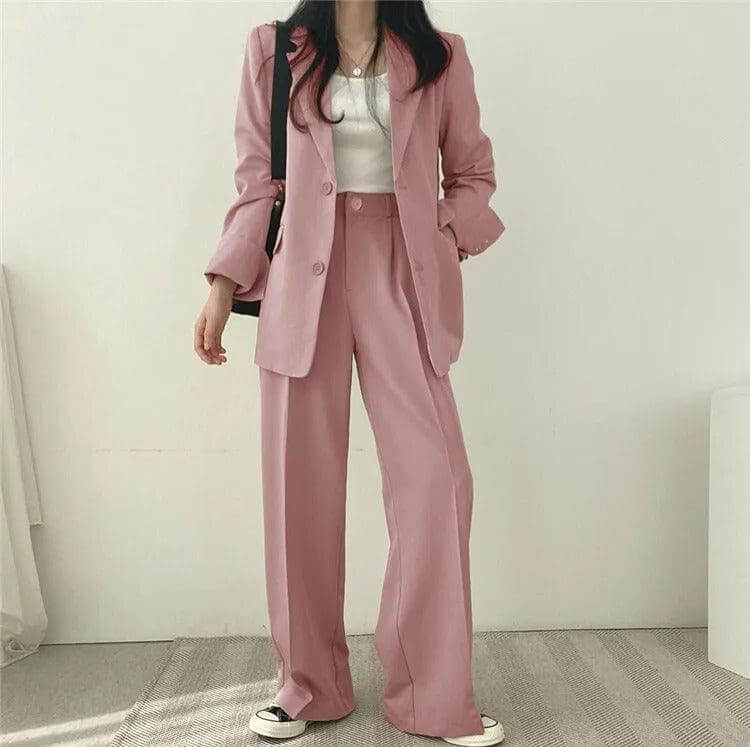 Modern women's tailored blazer and straight-leg pants ensemble, business attire.