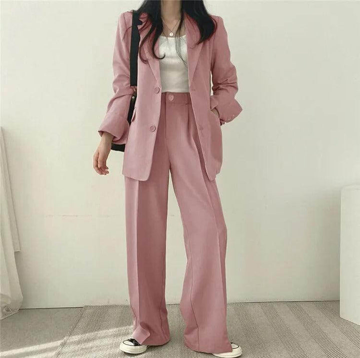 Modern women's tailored blazer and straight-leg pants ensemble, business attire.