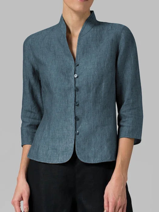 Close-up of a women's linen blazer. Breathable fabric and elegant mandarin collar detail, perfect for summer.