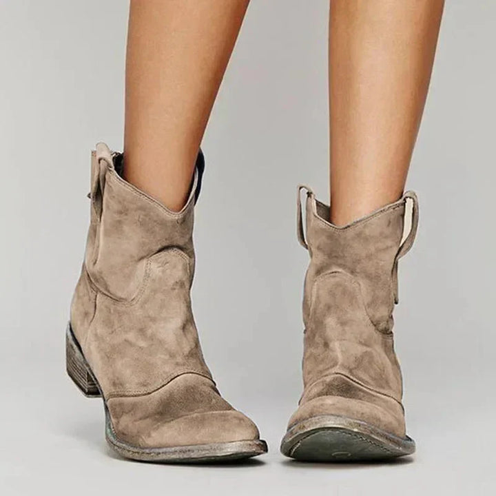 Women's tan suede western ankle boots with a comfortable block heel, perfect for casual fashion.