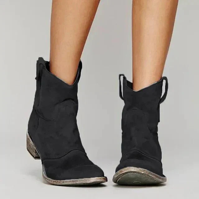 Stylish women's pull-on suede ankle boots in a western style, featuring a sturdy block heel.