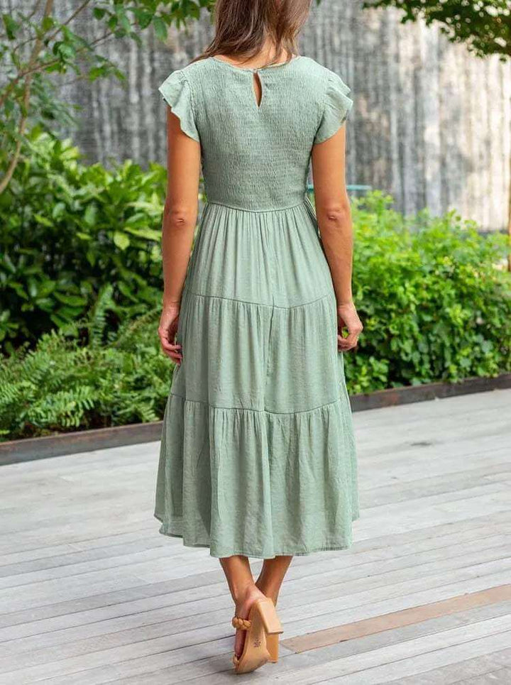 Rayon blend women's tiered midi dress, smocked, with graceful flutter sleeves, a flowy silhouette.
