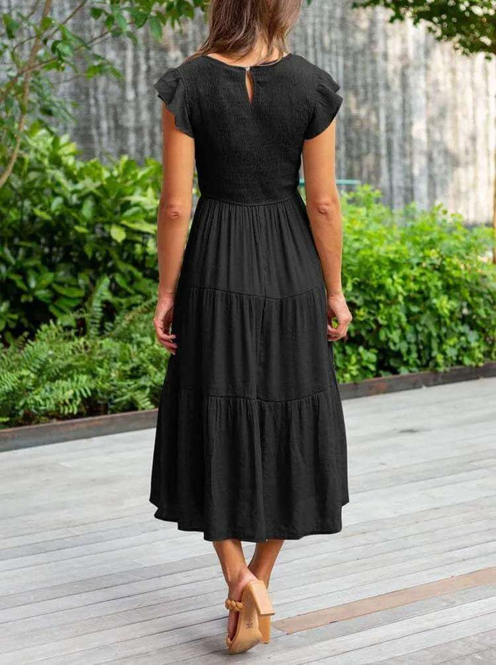Ladies' elegant tiered midi dress, perfect for warm weather, with flutter sleeves and a tiered skirt.