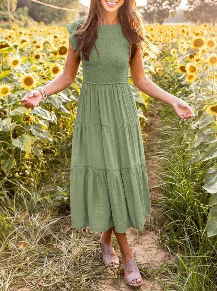 Elegant women's tiered midi dress featuring comfortable flutter sleeves and a versatile style.
