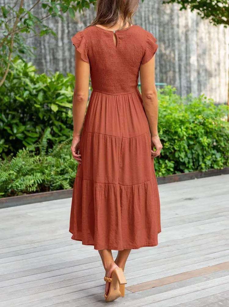 Chic women's tiered midi dress, perfect for summer, with graceful flutter sleeves and A-line cut.