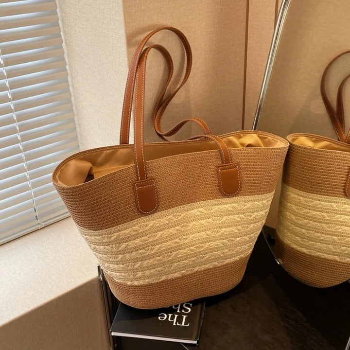 Elegant women's two-tone beach tote bag with sturdy shoulder straps, great for a stylish summer look.