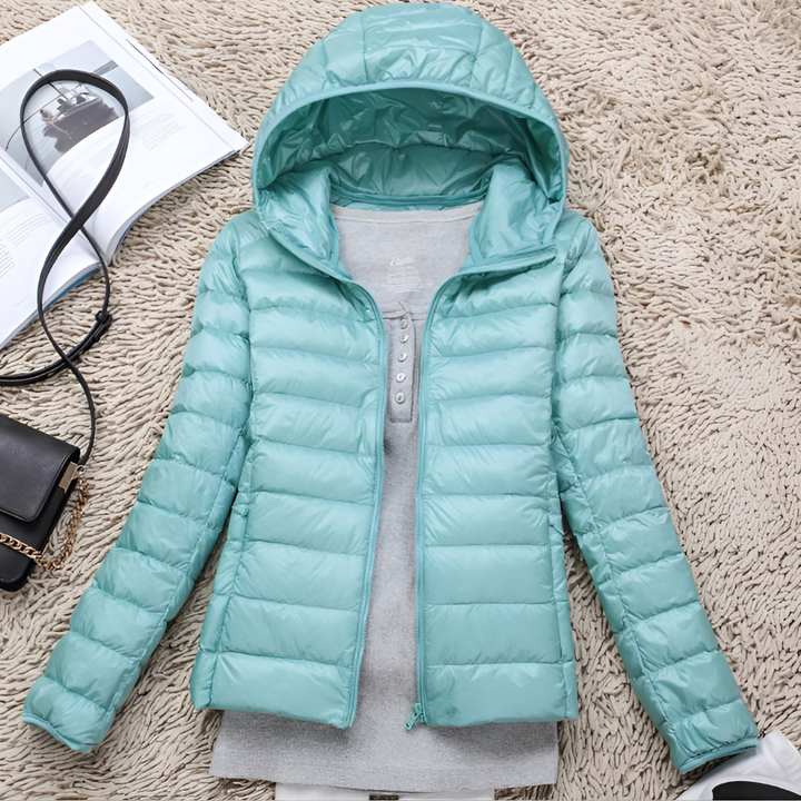 Warm women's packable hooded jacket. Ultra-light, comfortable outdoor wear, ideal for travel & all-season adventures.