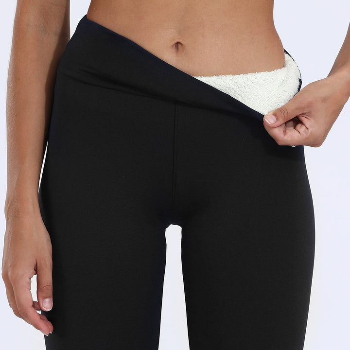 Women's warm thermal pants, high-waisted and lined for cold weather protection.