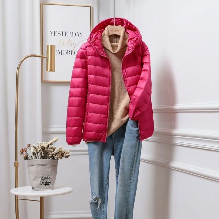 Women's ultralight hooded puffer jacket with zip pockets, practical for everyday use.