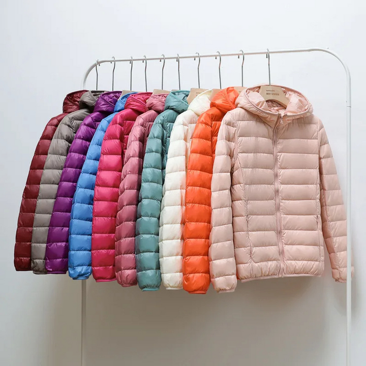 Women's ultralight travel puffer jacket with hood, perfect for hiking & outdoor trips.