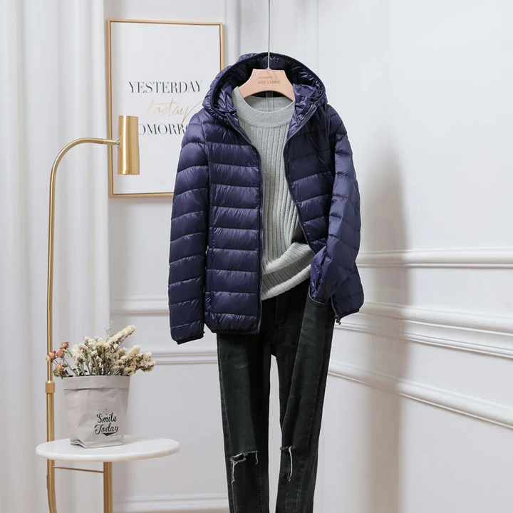 Close-up of quilted fabric on a women's ultralight foldable puffer jacket, showing insulation.