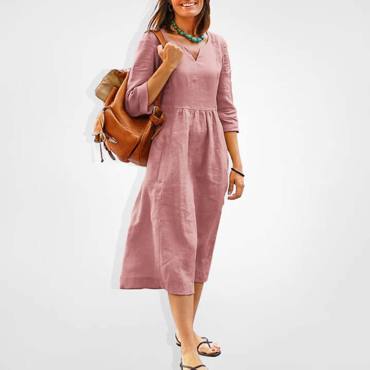 Women's V-neck empire waist midi dress in rayon blend, perfect for versatile casual and elegant spring/summer fashion.