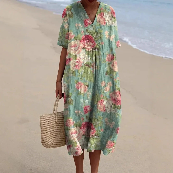 Flowy summer midi dress with vibrant floral print & V-neck. Perfect women's beachwear or casual vacation outfit.