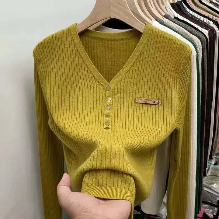 Casual women's V-neck knitted sweater in a classic design. Comfortable long-sleeve jumper for everyday fall fashion.