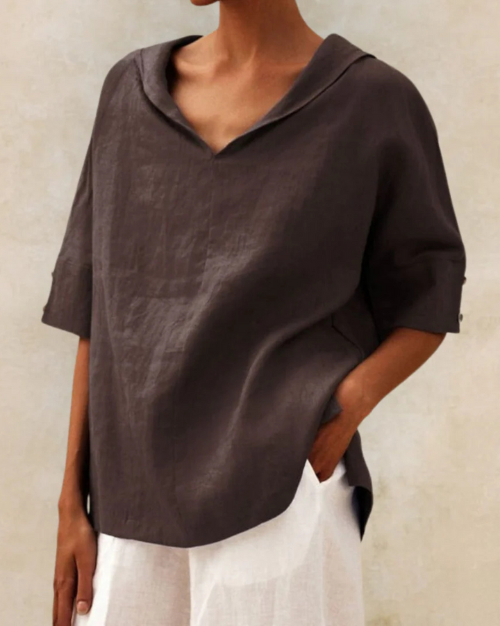 Breathable women's linen shirt with V-neck & half sleeves, offering comfort for spring & summer casual style.