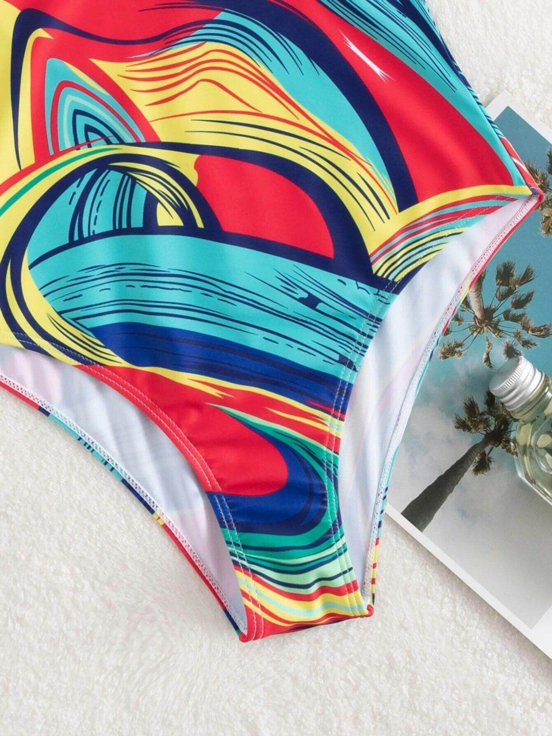 Elegant women's V-neck one-piece swimsuit, showcasing sleek design, perfect for beach & poolside activities.