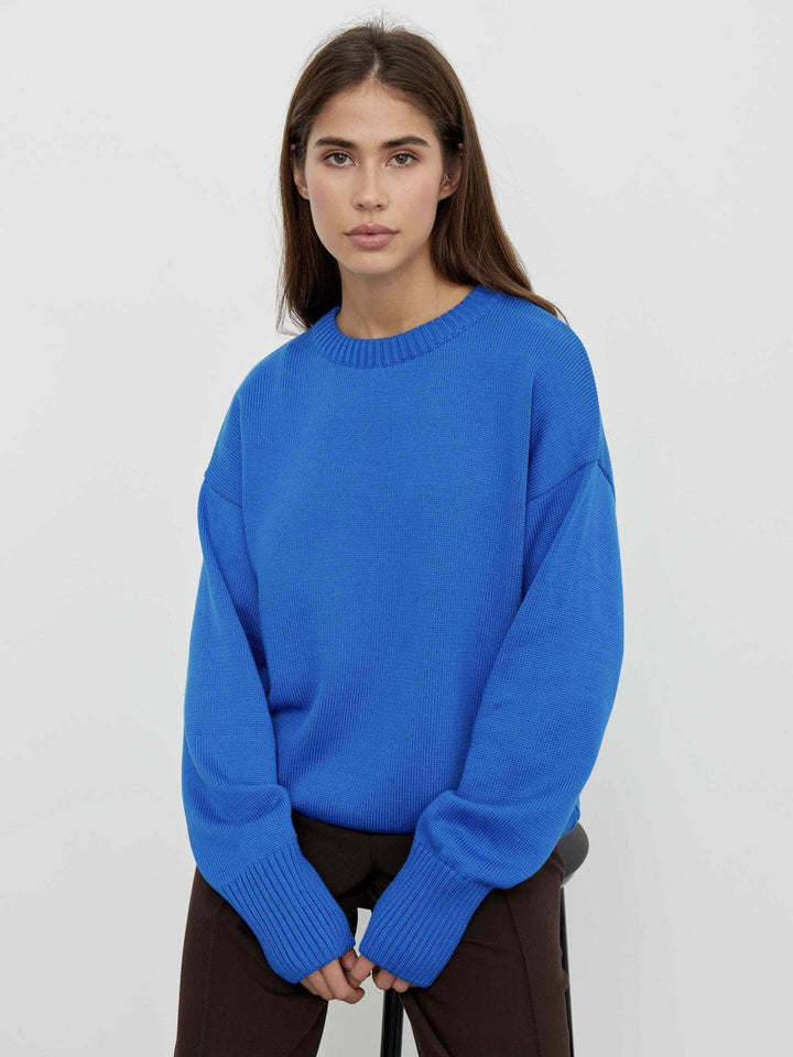 Soft ribbed knit V-neck sweater for women. Comfortable long sleeve knit top, stylish winter wear.