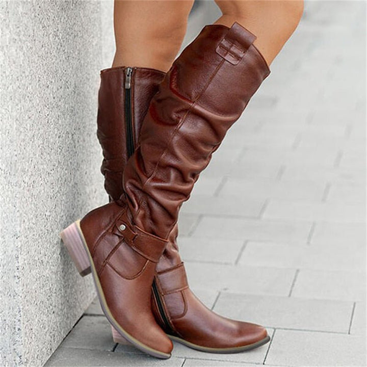 Women's elegant slouchy flat knee-high boots, offering versatile and comfortable everyday chic.