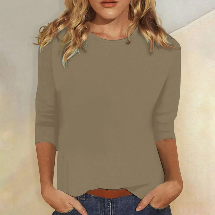 Women's stylish round neck 3/4 sleeve casual top. Versatile, relaxed fit for everyday comfort.