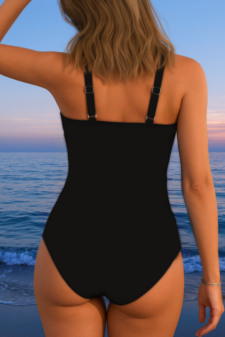 Woman wearing a vibrant print surplice swimsuit, ready for a luxurious beach vacation or pool day. Flattering fit.